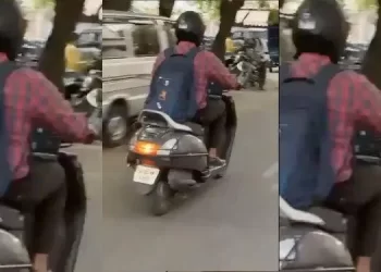 Man Works on Laptop While Riding Scooter