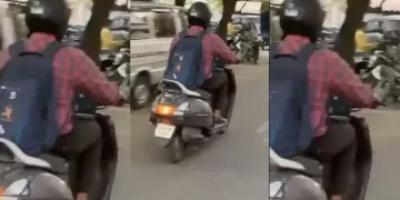 Man Works on Laptop While Riding Scooter